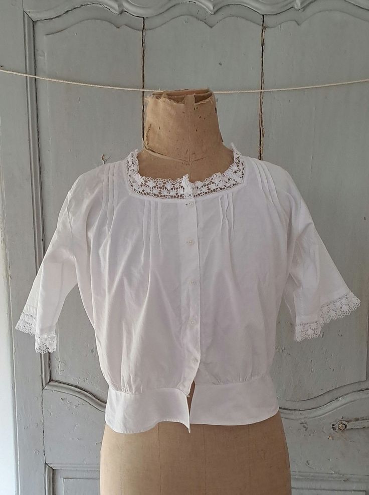 Antique french fine cotton chemise with pleat and lace detail, milk glass buttons. In very good antique condition. one tiny hole, see picture. Measures Bust 40" 102cm Shoulder to hem 18" 46cm Arm hole diameter 8" 20cm 74g Victorian Lace Trim Top For Daywear, Victorian Cotton Top With Lace Trim, Victorian Cotton Tops With Lace Trim, Victorian Cotton Tops For Summer, Cotton Broderie Anglaise Blouse For Daywear, Cotton Blouse With Broderie Anglaise For Daywear, Vintage Broderie Anglaise Blouse For Daywear, Victorian Cotton Blouse With Lace Collar, Victorian Blouse With Buttons For Daywear