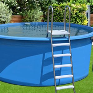 an above ground swimming pool with ladders on the side and green grass around it