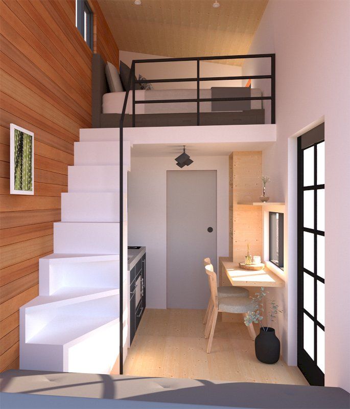 the interior of a small apartment with stairs leading to an upper level bedroom and kitchen