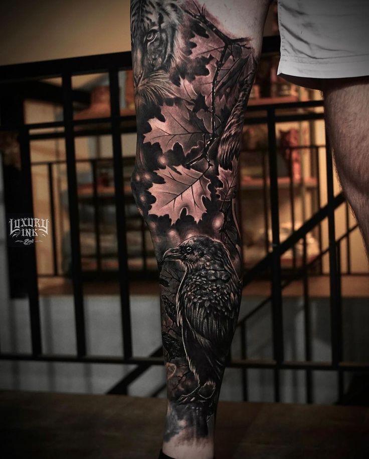 a man's leg with an eagle and oak leaves tattoo on his left arm