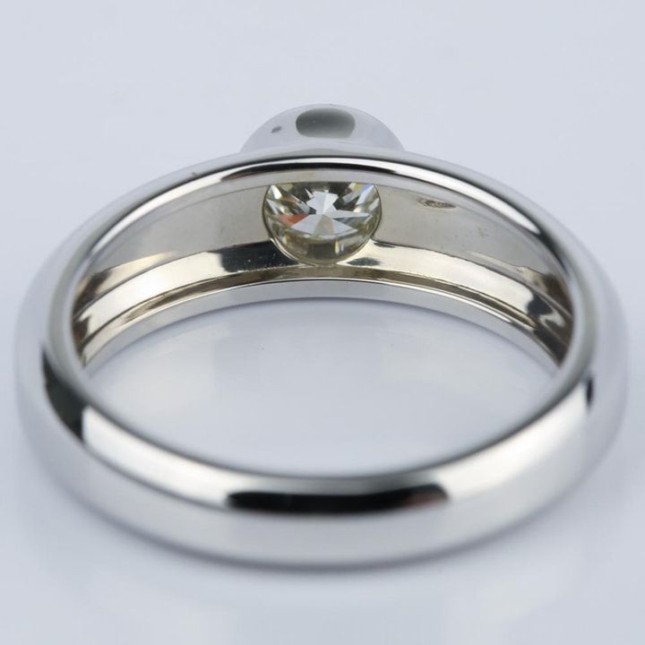 a close up view of a ring with a diamond in the center on a white background