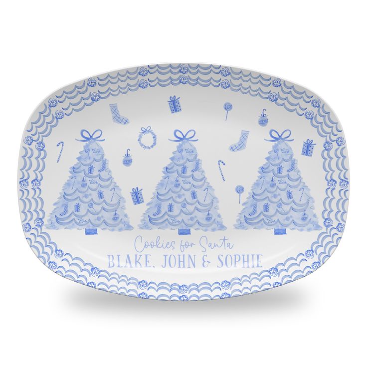 a blue and white platter with christmas trees on it