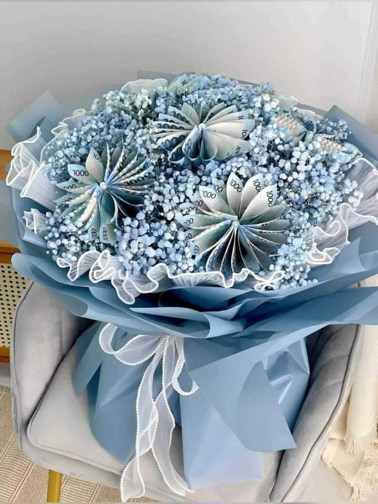 a bouquet of blue flowers sitting on top of a chair