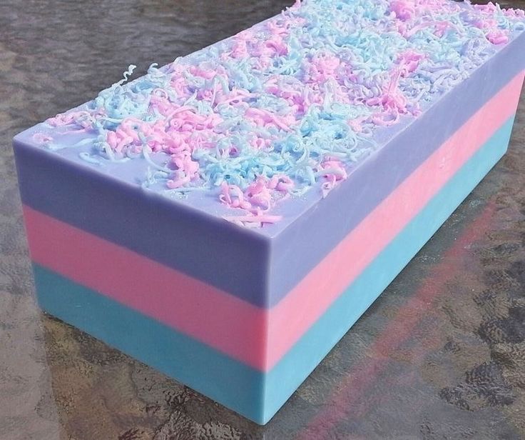 a multicolored cake sitting on top of a table