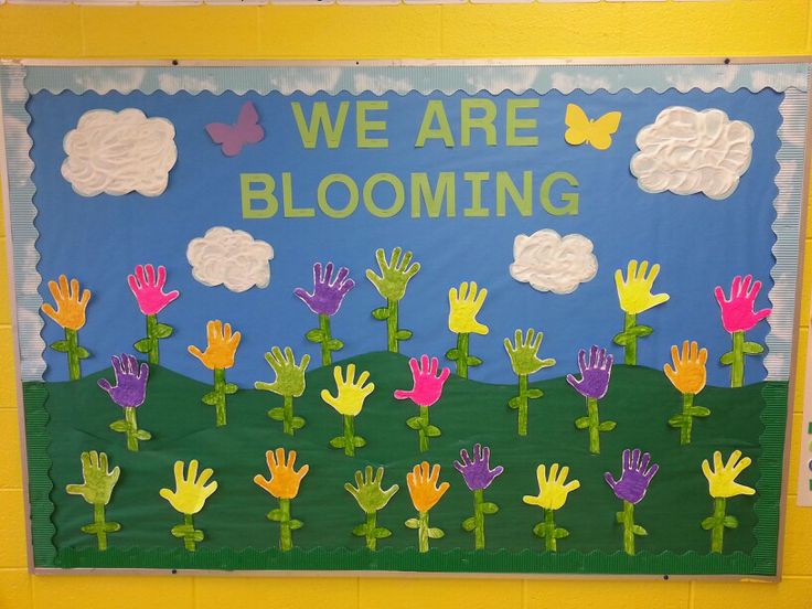 we are blooming bulletin board with handprints on it