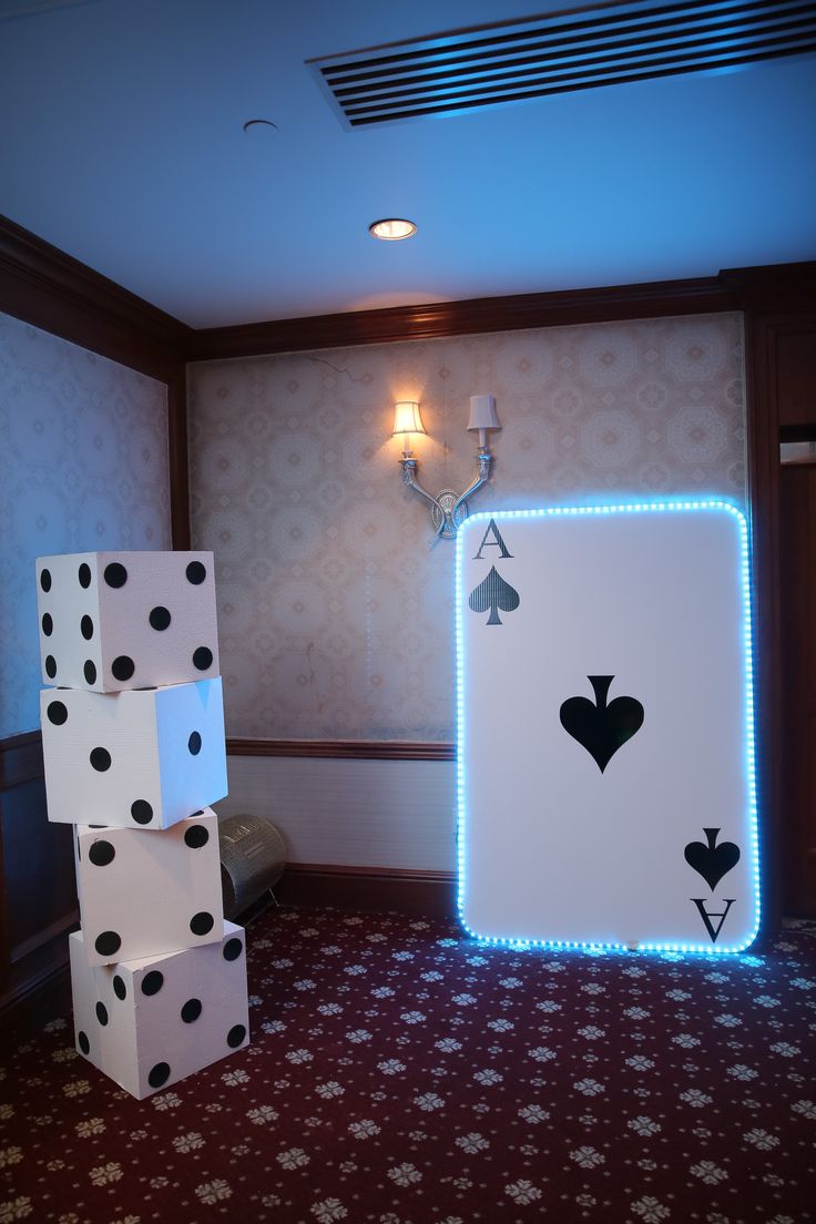 the room is decorated with dices and lights for playing cards or dominos on the floor