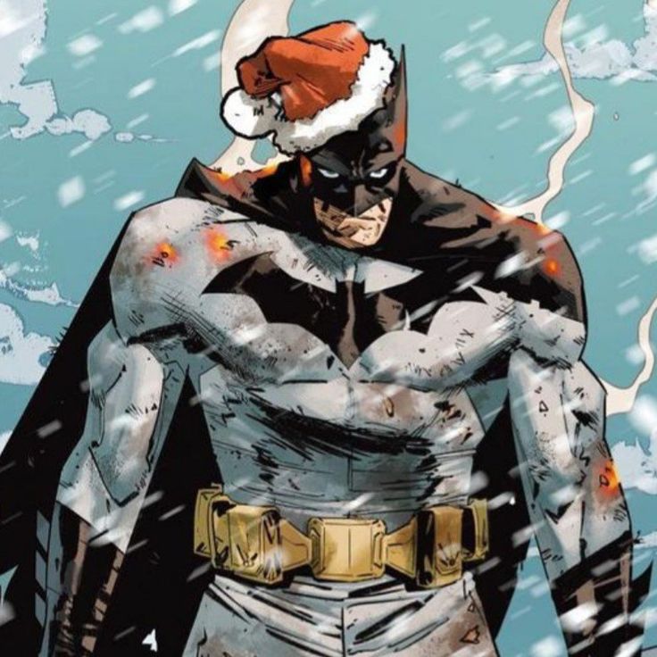 batman in the snow wearing a santa hat and holding his hands on his hipss