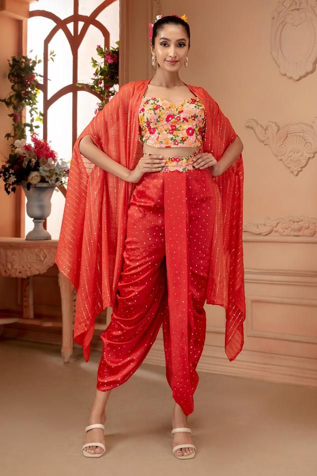 Orange padded blouse with resham floral embroidery. Comes with dhoti pant and cape.
Components: 3
Pattern: Embroidered
Type Of Work: Resham, Badla
Neckline: Sweetheart
Sleeve Type: Flared
Fabric: Georgette and chanderi silk
Color: Orange
Other Details: 
Length: 
Dhoti pant: 43 inches
Blouse: 15.5 inches
Cape: 40 inches
Occasion: Destination Wedding - Aza Fashions Fitted Festive Pant Set With Dupatta, Festive Front Open Georgette Set, Designer Front Open Sets For Diwali, Fitted Pant Set For Navratri Designer Wear, Navratri Semi-stitched Pant Set With Pallu, Traditional Semi-stitched Front Open Sets, Bollywood Style Pant Set With Sheer Dupatta For Festivals, Traditional Fitted Pant Set With Dupatta, Festive Designer Sets With Front Open Design