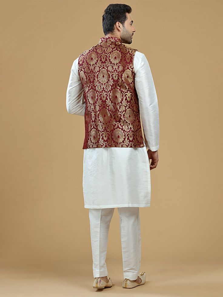 A gold zari brocade vest to pair with any kurta with statement button closures at the front. Occasion: Style this vest with pajama pants and a kurta for a welcome dinner or sangeet night, or style it with a any dress shirt and trousers for a sleek Indian wedding reception look! WASH CARE INSTRUCTIONS - Please Dry clean only. Slight color variation is possible due to digital photography. **Kurta & Pajama not included Sleeveless Nehru Jacket With Zari Work, Sleeveless Nehru Jacket With Zari Work For Transitional Season, Sleeveless Bandhgala For Eid, Traditional Sleeveless Bandhgala With Zari Work, Traditional Sleeveless Kurta With Zari Work, Designer Sleeveless Kurta For Transitional Season, Bollywood Style Sleeveless Dabka Set, Sleeveless Bandhgala For Festivals, Sleeveless Nehru Jacket For Diwali