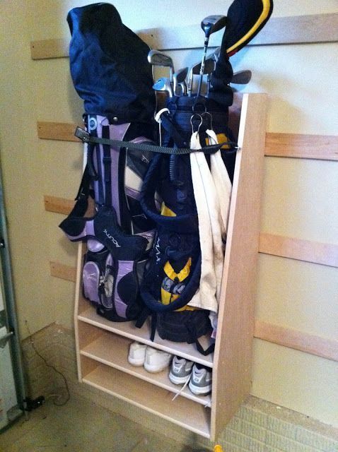 a wooden shelf filled with lots of golf gear and equipment on it's side