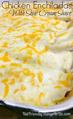 chicken enchiladas with sour cream sauce in a casserole dish