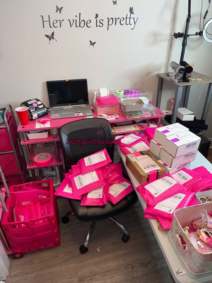 a desk covered in lots of pink boxes