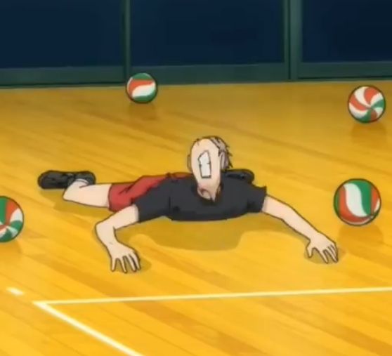 a man laying on the floor with balls in front of him