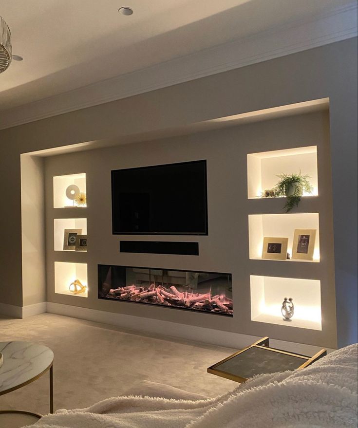 a living room filled with furniture and a flat screen tv mounted to the side of a wall