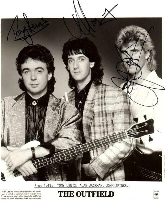 an autographed photo of two men with guitars