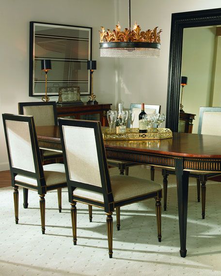 a dining room table with chairs and a large mirror