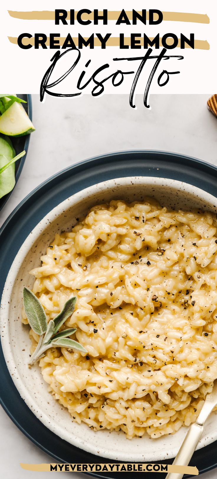 a bowl of creamy lemon risotto on a white table with an olive sprig