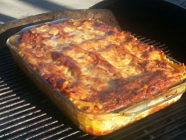 a casserole is cooking on an outdoor grill