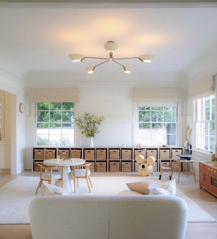 a living room filled with furniture and lots of windows