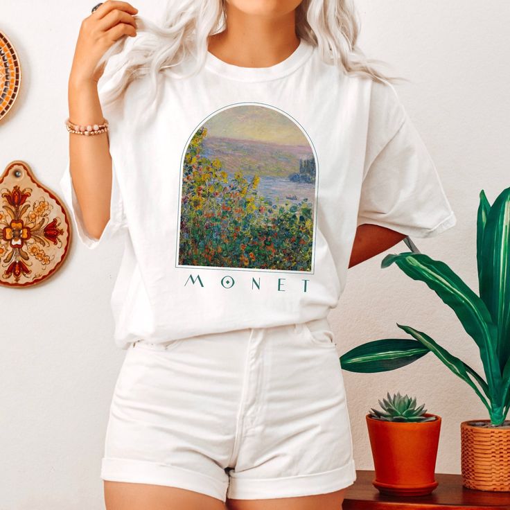 a woman wearing white shorts and a t - shirt with the words monet on it