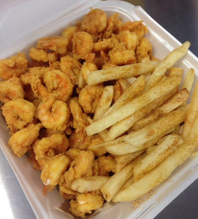 a plastic container filled with fried food on top of a table