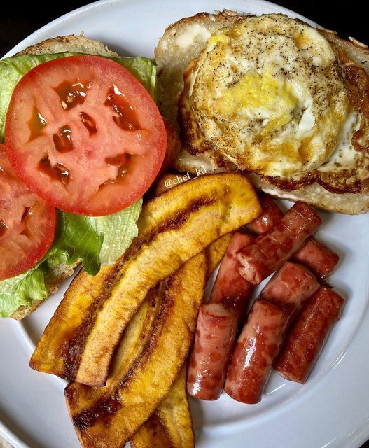 a white plate topped with breakfast foods and french fries