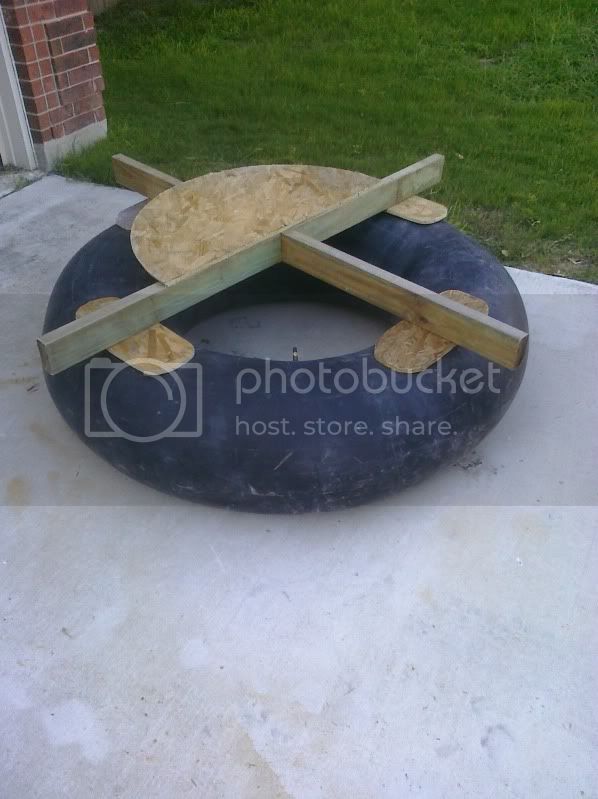 an inflatable raft sitting on top of a cement ground next to a brick building