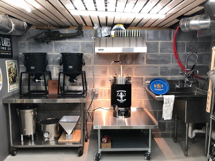 an industrial kitchen with stainless steel counters and appliances on wheels in the center of the room