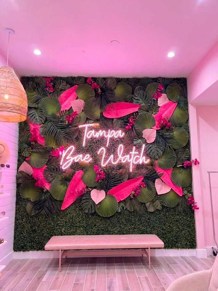 there is a pink wall in the room with flowers on it and a sign that says tampa blvd