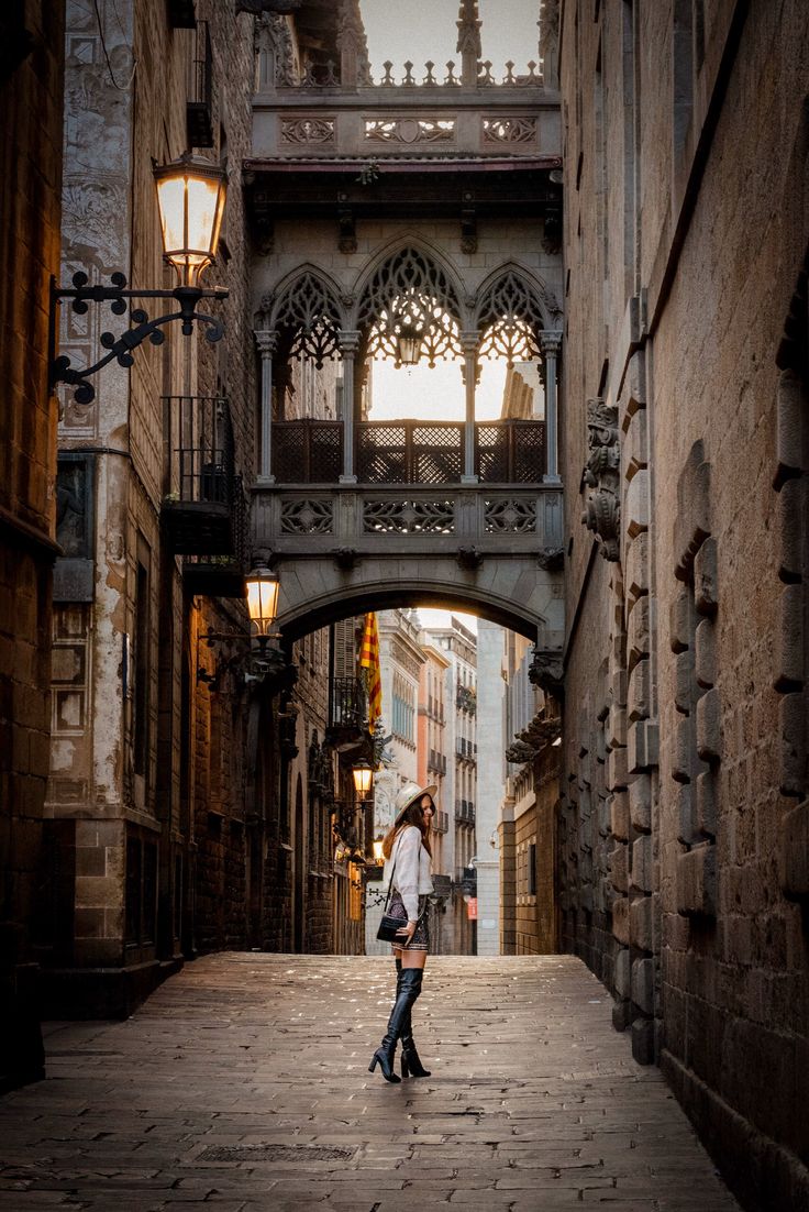 a woman is standing in an alley way