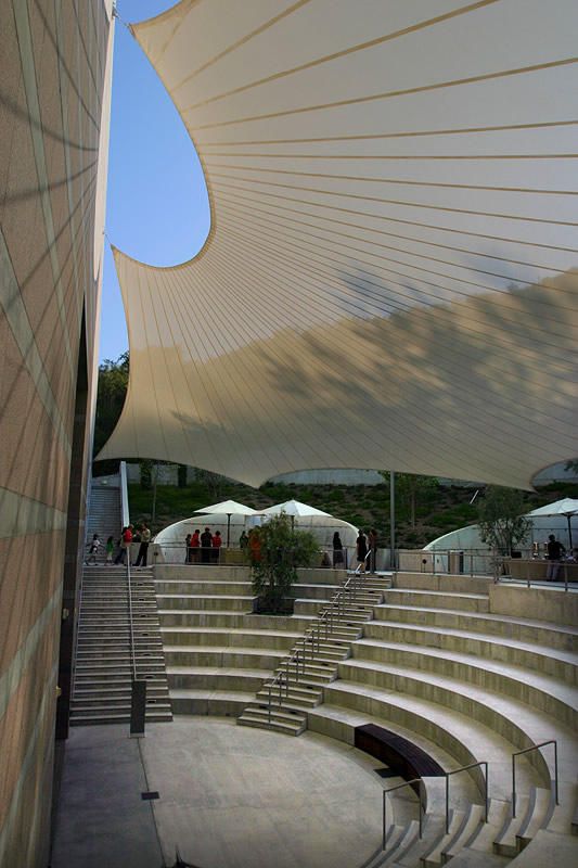 an outdoor seating area with steps and umbrellas