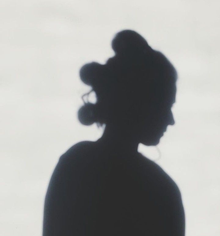 the silhouette of a woman's head against a white background