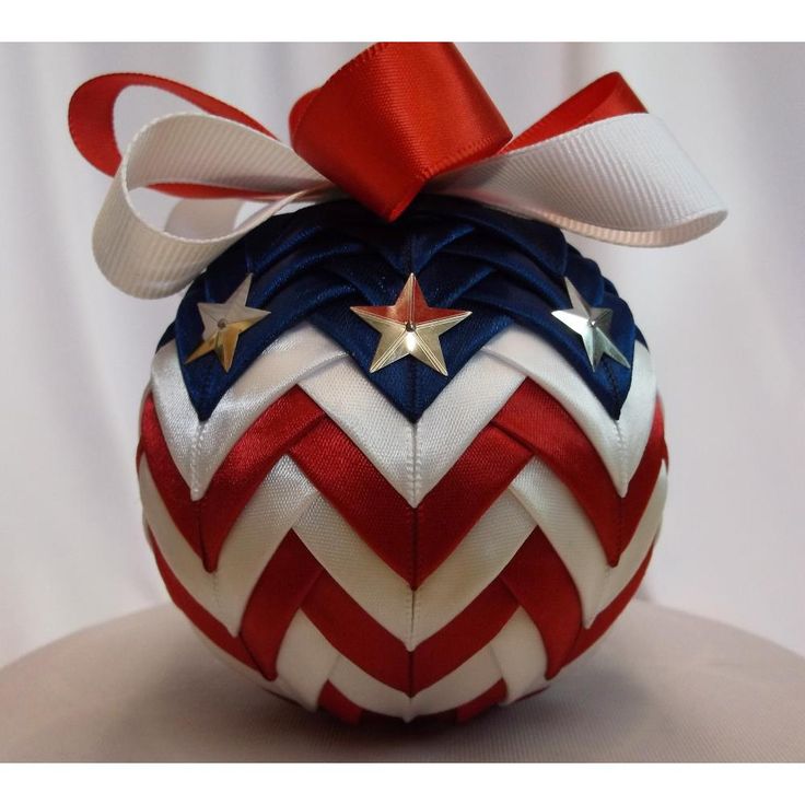 a red, white and blue ornament with a bow on it's top