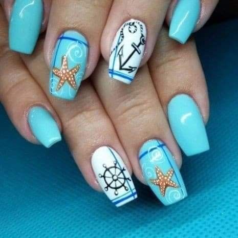 blue and white nails with an anchor, starfish and other things on it's fingertips