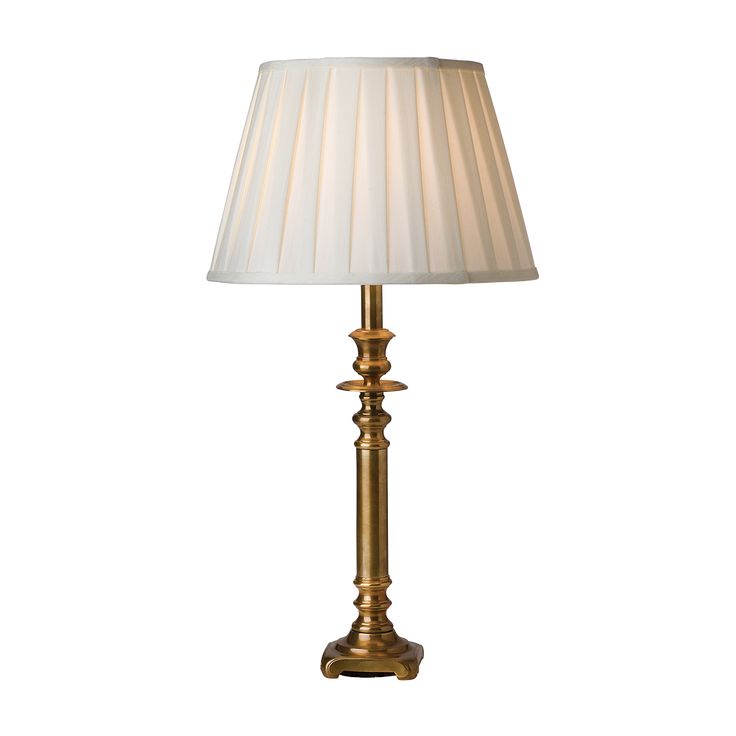 a gold lamp with a white shade on it