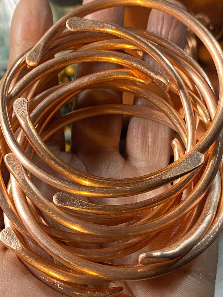 Solid copper bangles are sold in a set of 5 Each bangle in the set is hammered and formed by hand making each piece one of a kind. Please state your desired size (s-m-l) when placing you order Thank you in advance *PLEASE NOTE BRASS AND COPPER NATURALLY PATINAS OVER TIME. Research what patina means as well as how to clean/ shine and store to gain better innerstand of organic materials. Copper Bangles, Bracelets Collection, Bangles And Bracelets, Colour Analysis, Seasonal Color Analysis, Vintage Bangles, Bronze Jewelry, Hand Making, Bangles Bracelets