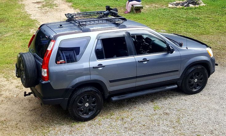 an suv parked on the side of a dirt road