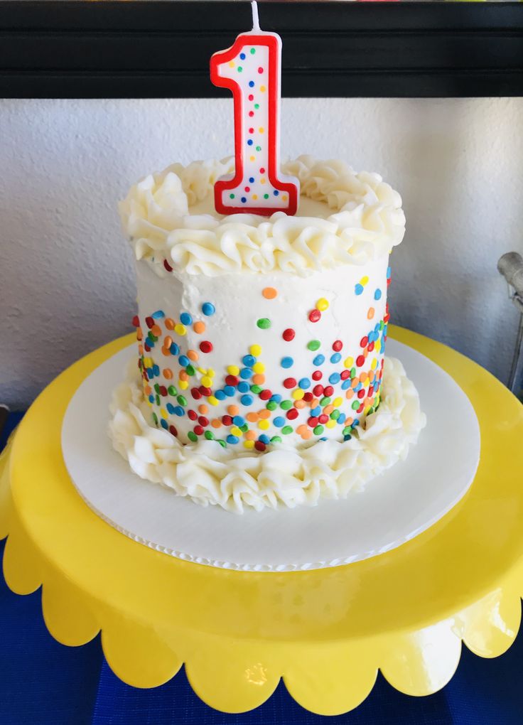 a birthday cake with white frosting and colorful sprinkles