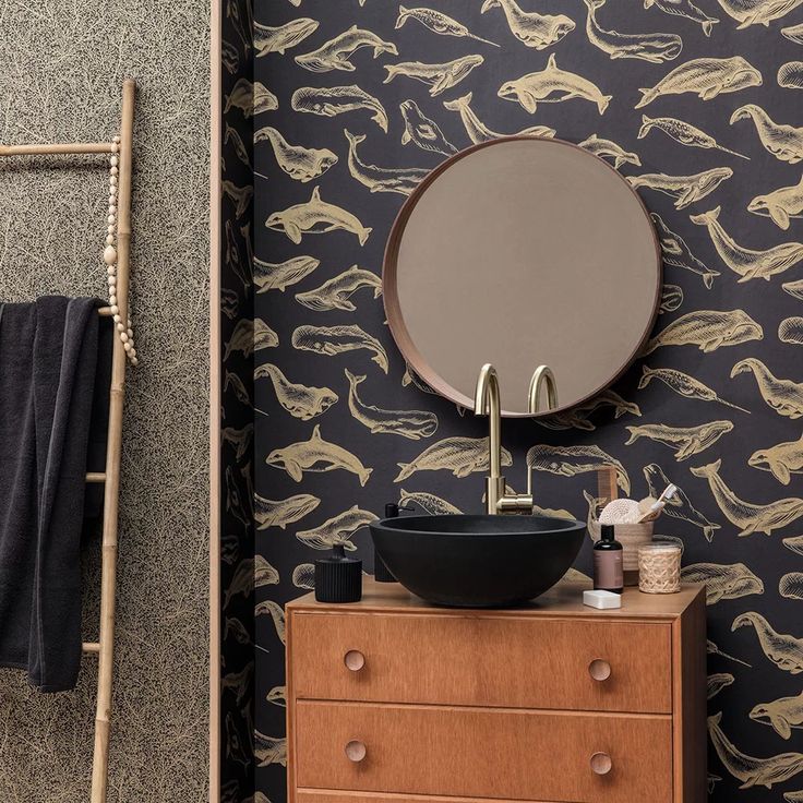 a bathroom with black and gold wallpaper, sink and mirror in the corner next to a ladder