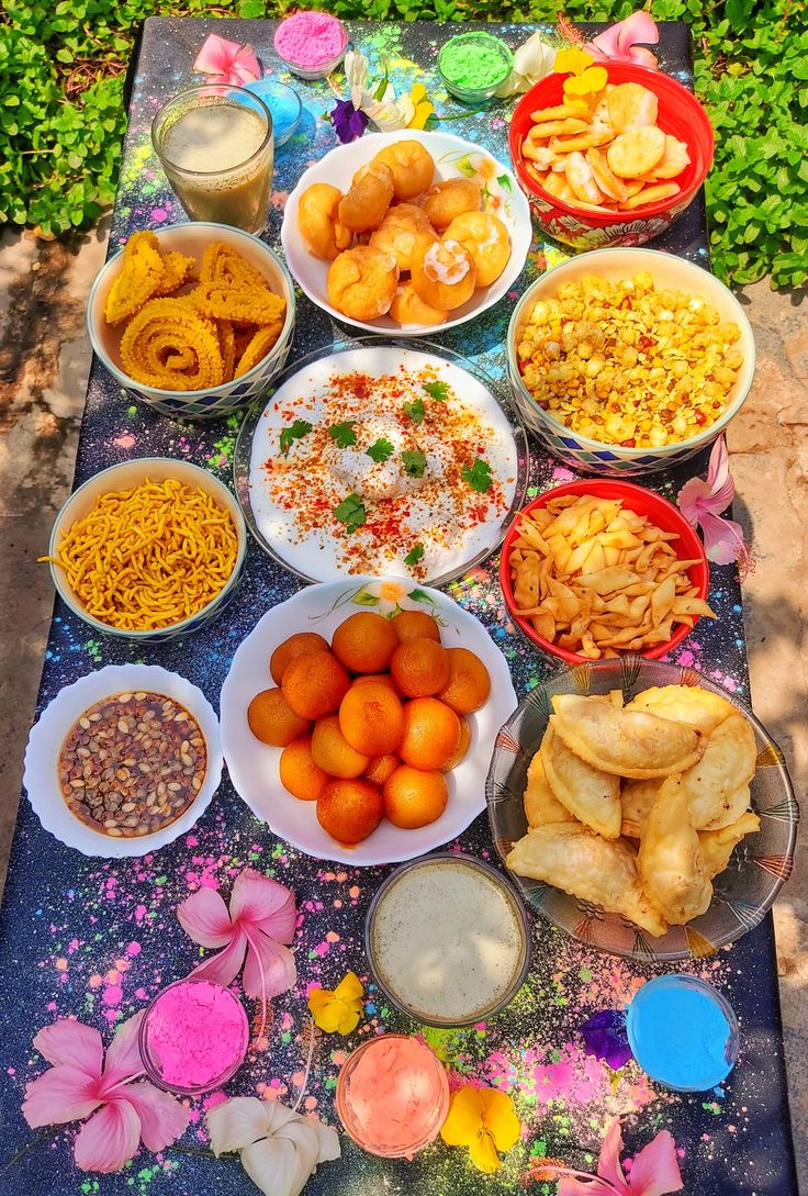 a table topped with lots of different types of food on top of plates and bowls