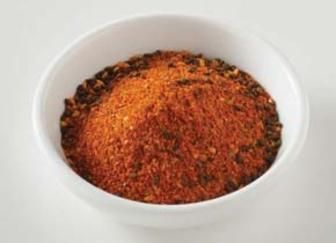 a white bowl filled with spices on top of a table