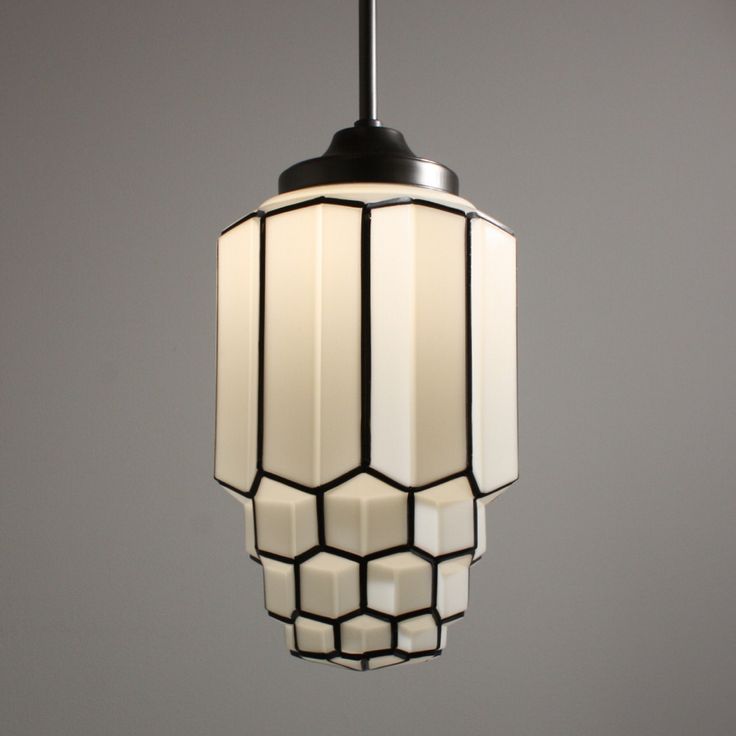 a light fixture hanging from a ceiling in a room with gray walls and flooring