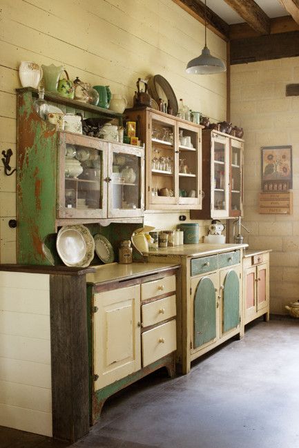 an old fashioned kitchen with lots of cupboards