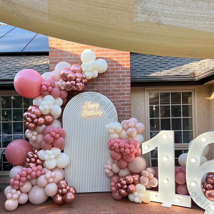 a house made out of balloons with the number sixteen on it