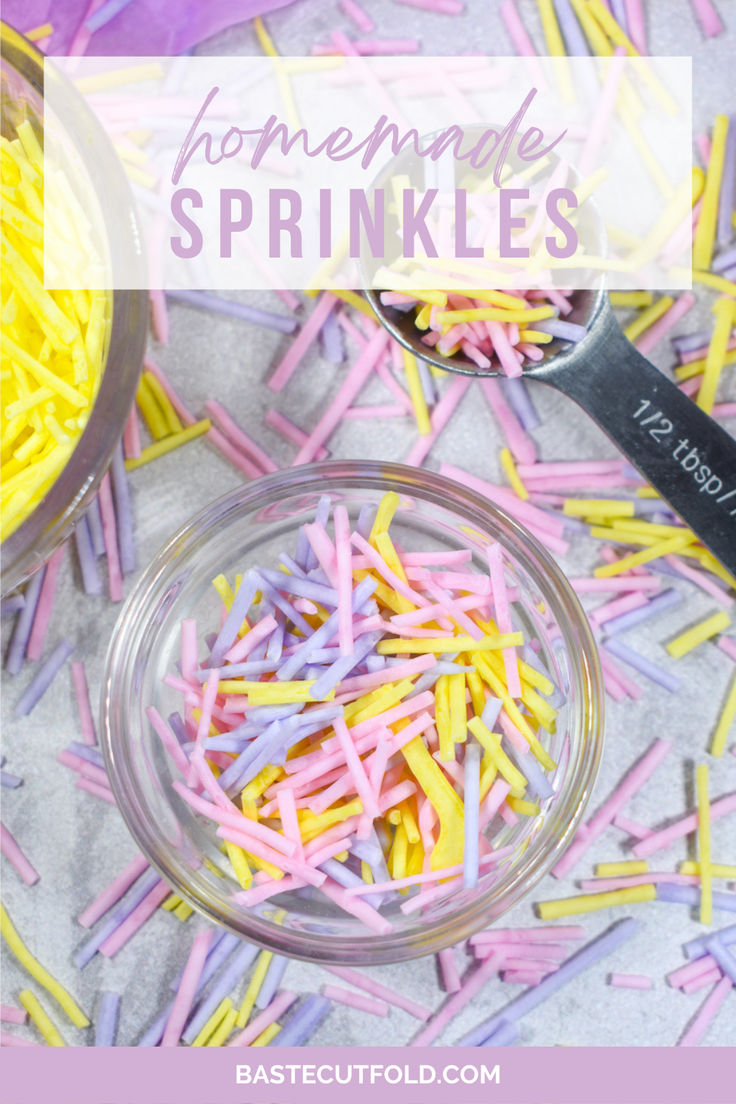 some sprinkles in a glass bowl next to a measuring cup and spoon