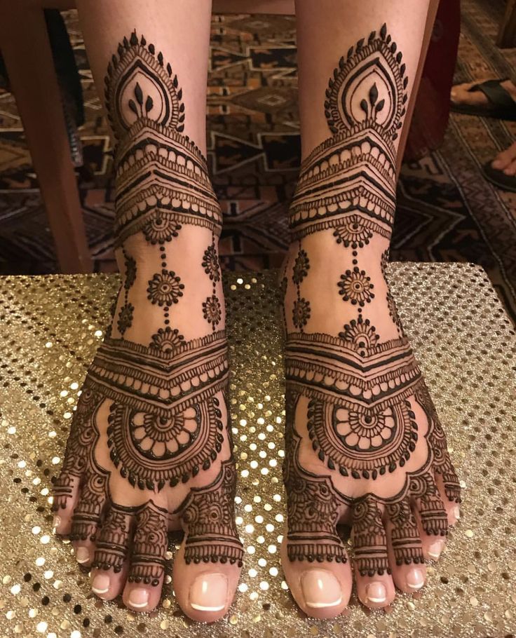 the feet are decorated with henna designs