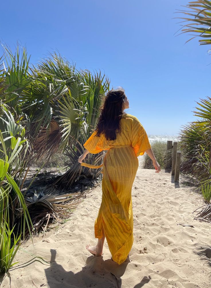 A beautiful handcrafted unisex kimono long robe dress by the hand tie-dye Removable waist tie closure Side slits at hem 100% Soft Rayon Hand wash in cold water, hang dry. Wear on the beach when on the vacation as well home Sizes: One size -One size fit all (S-L) Chest & Hip: 66 inches. Length: 54 inches. 🧍🏽‍♀️Ginger: Model height is 158cm/5.2ft, American small size (31-25-33") - Each piece is handmade, and due to the nature of the fabric and process, each piece may vary slightly in color a Yellow Summer Kimono For Beach Cover-up, Beach Cover-up Kimono With Tie Waist, Flowy Cover-up With Kimono Sleeves For Festivals, Bohemian Rayon Kimono For Beach Cover-up, Bohemian Wrap Kimono With Tie Waist, Summer Bohemian Robe With Tie Waist, Flowy Long Robe For Beach Cover-up, Bohemian Festival Kimono With Tie Waist, Flowy Rayon Kimono For Beach