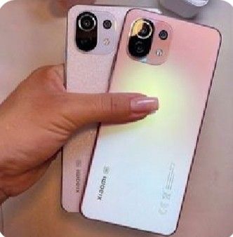 two iphones are being held next to each other with their fingers on the back