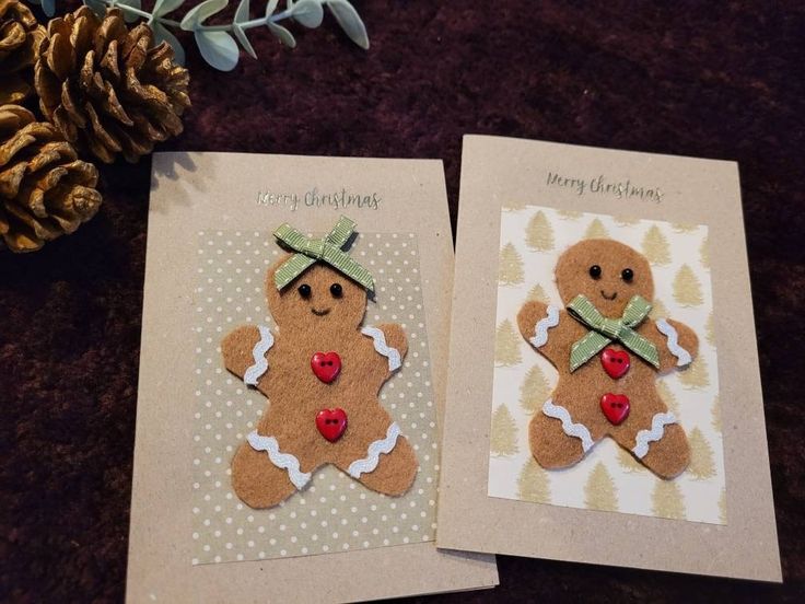 two christmas cards with gingerbreads on them next to a pine cone and plant