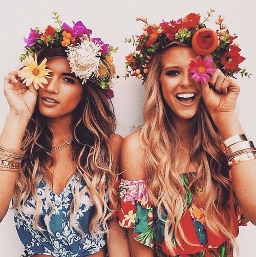 two beautiful women with flower crowns on their heads